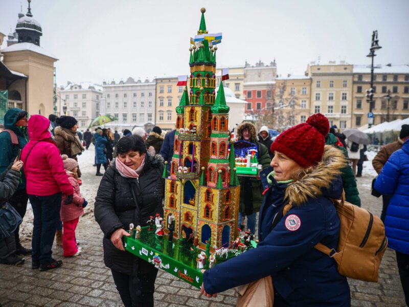 ​Woman carrying a castle at the 81st Nativity Scene Contest at the Main Square in Krakow, Poland