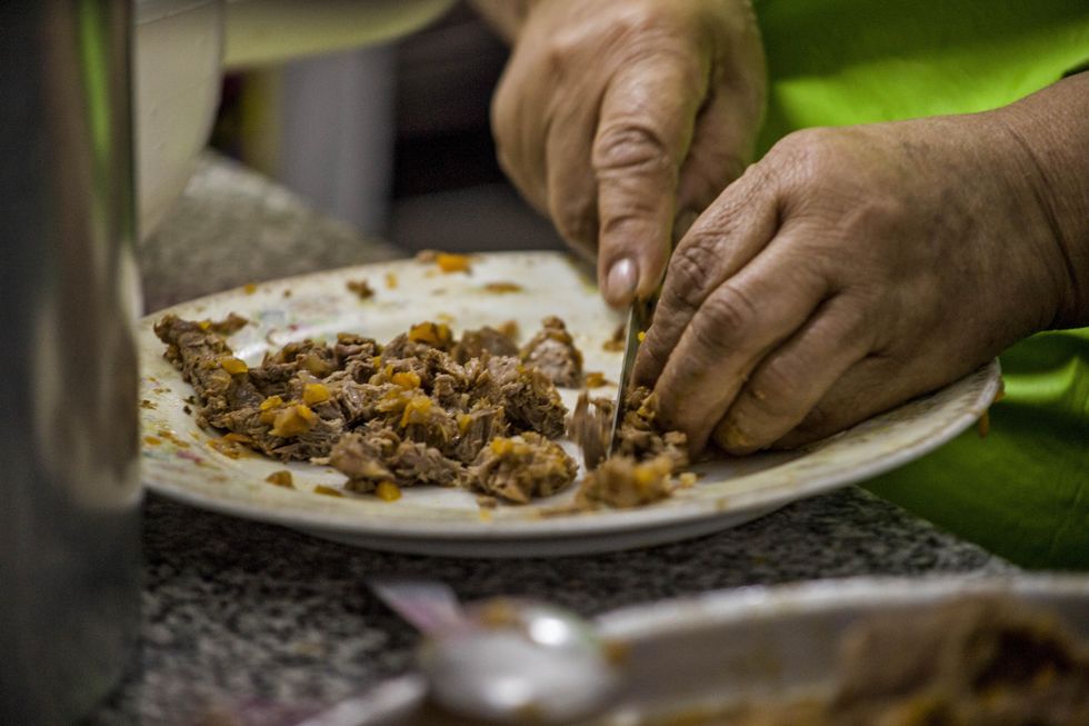 ​Woman preparing food for young people