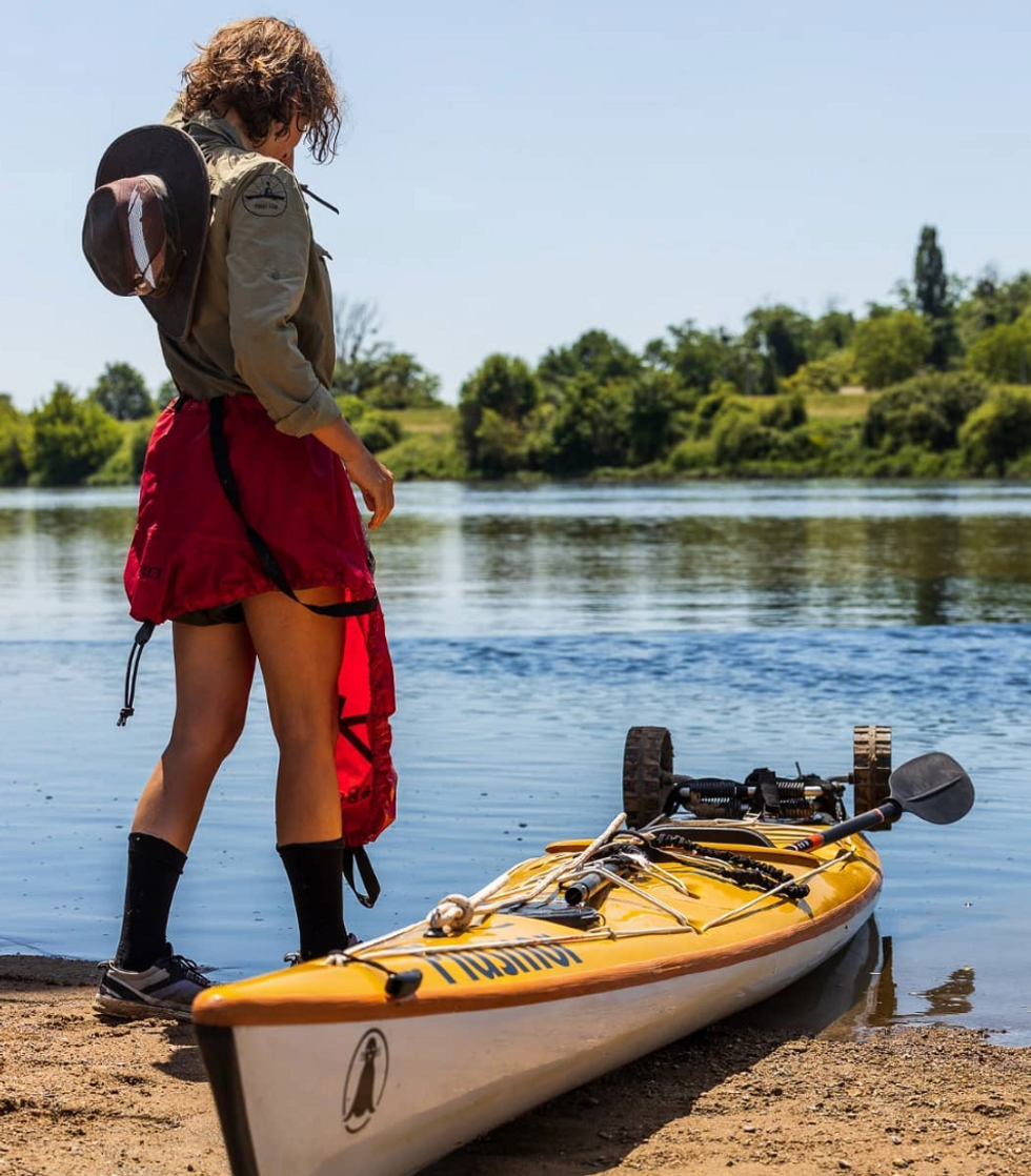 ​Women and her kayak on the banks of the Loire river in France.