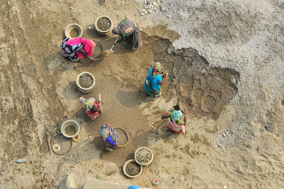 ​Women stone workers are working to collect stone in the traditional way on the banks of Jaflong river in Goainghat upazila of Sylhet.