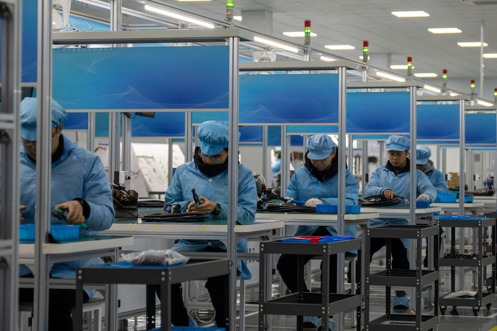 ​Workers produce electric vehicle charging pile harness at a workshop of an electric vehicle charging pile enterprise in Hefei circular Economy Demonstration Park in Hefei, Anhui province, China, Feb 28, 2024.