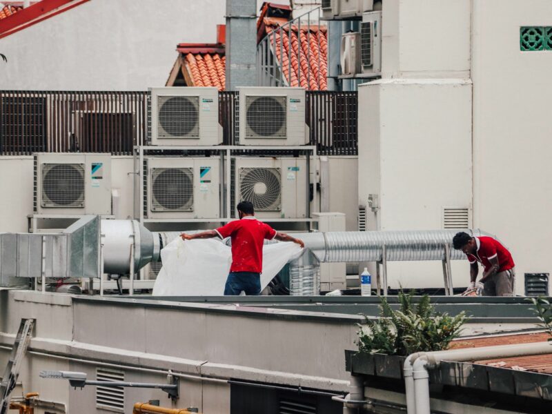 ​Workers repair air conditioning in Singapore