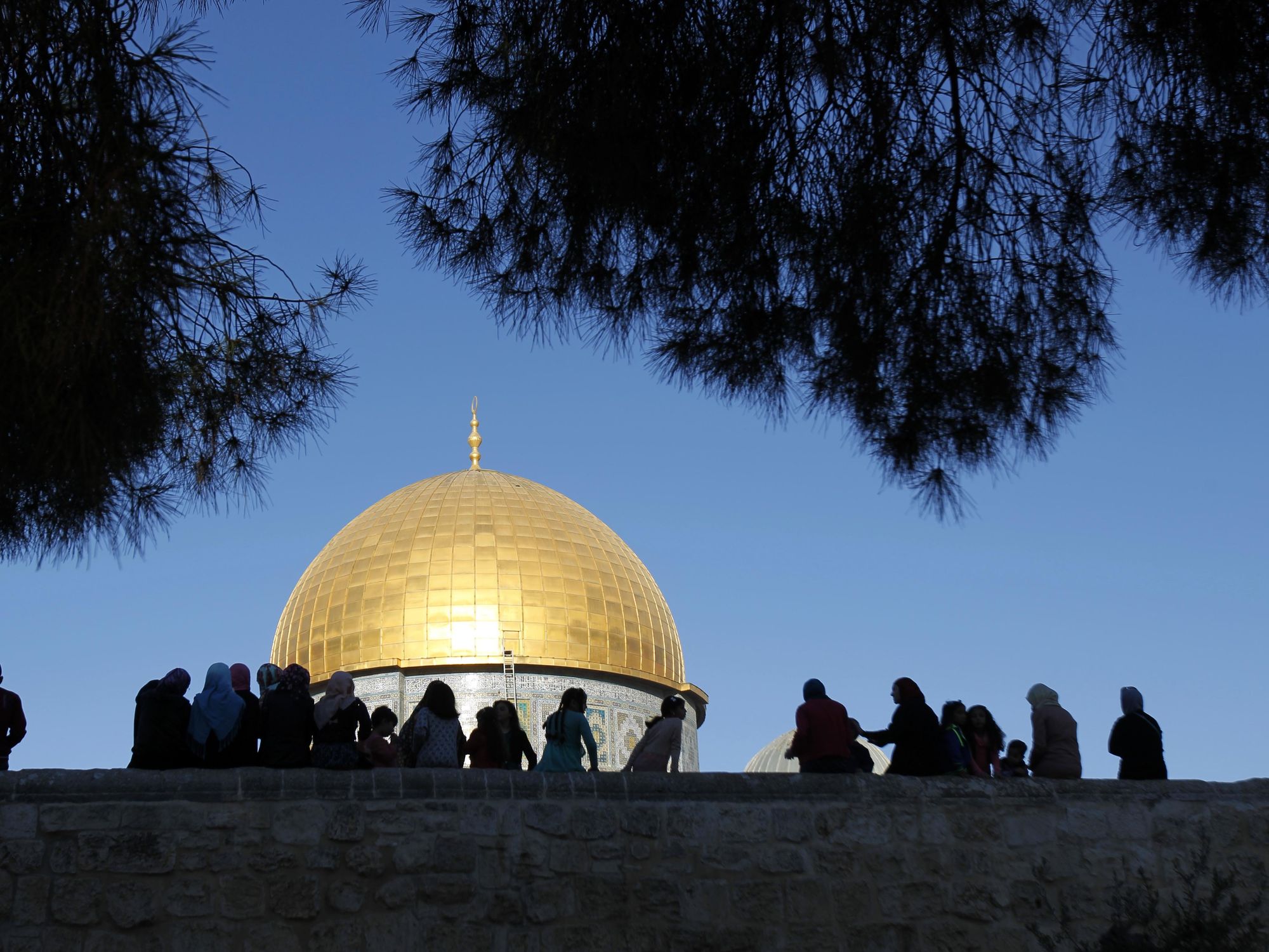​Worshippers sit in front of the Dome of the Rock at the compound known to Muslims as al-Haram al-Sharif and to Jews as the Temple Mount in Jerusalem's Old city.