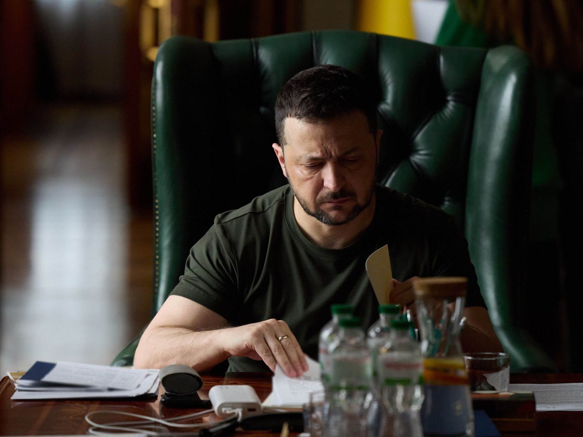 ​Zelensky looking over documents.
