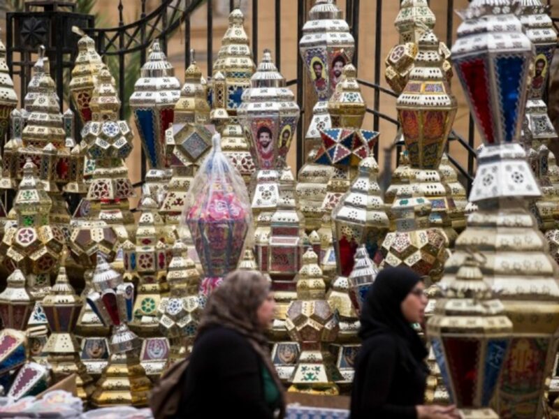 Egyptian women pass by Ramadan lanterns in Cairo, in May 2018.