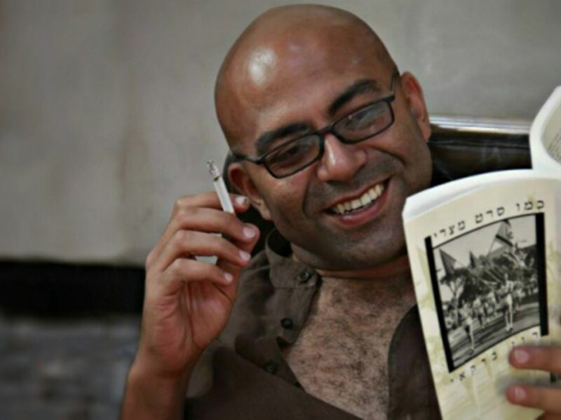Egyptian writer Nael Eltoukhy reading a book in Hebrew.