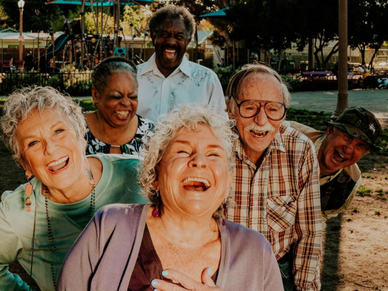 Elderly Americans laughing in a staged photo.