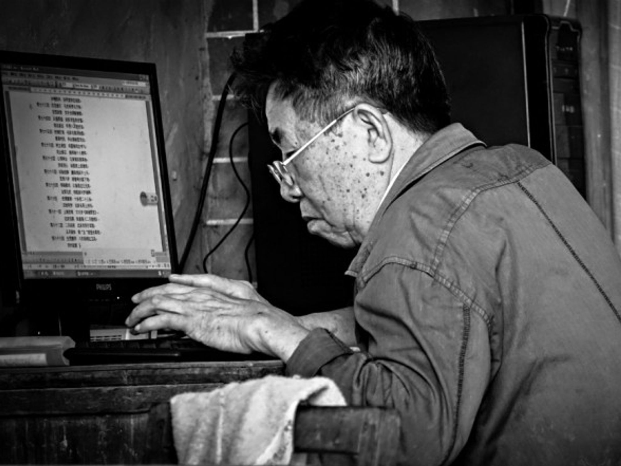 Elderly man on a computer in Guilin, China