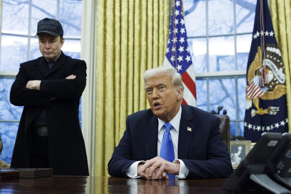 Elon Musk looks on as US President Donald Trump speaks to the media, in the Oval Office of the White House.