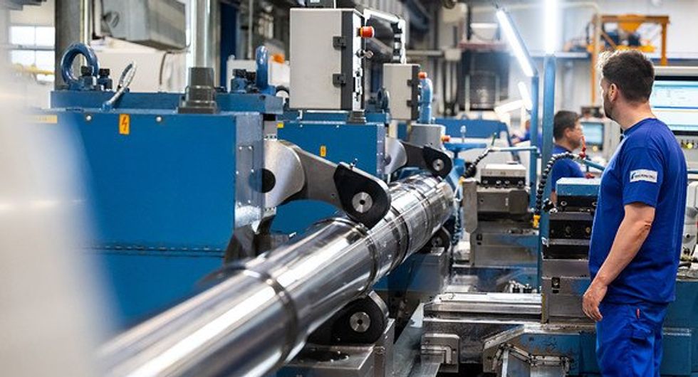 Employee working on a gun in a german plant.
