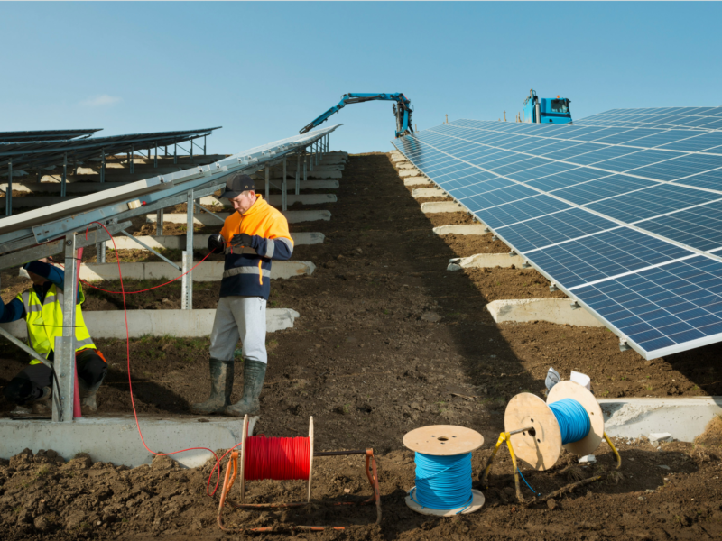 Engineers installing solar panels on a new solar farm.