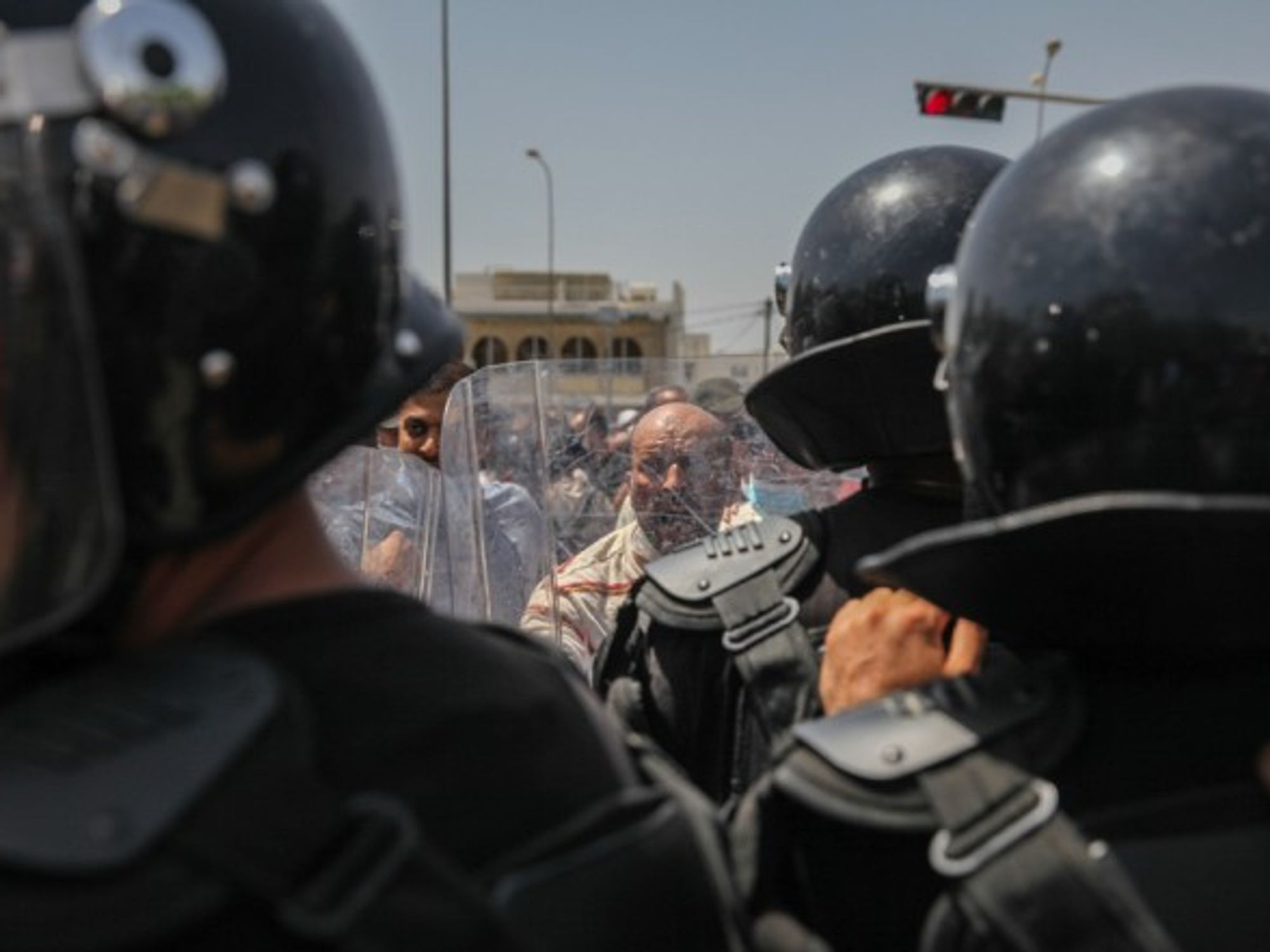 Ennahdha supporters facing the riot police during a protest in Tunis on July 26