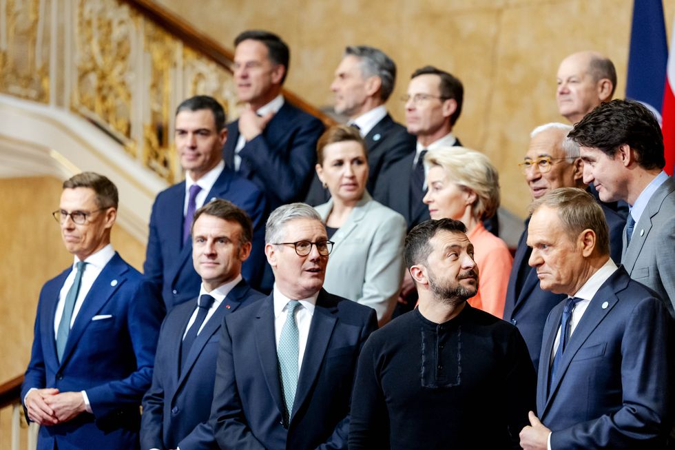 European leaders take a group photo, with Emmanuel Macron, Keir Starmer, Voloymyr Zelensky, Olaf Sholz, and Justin Trudeau clear in the foreground.