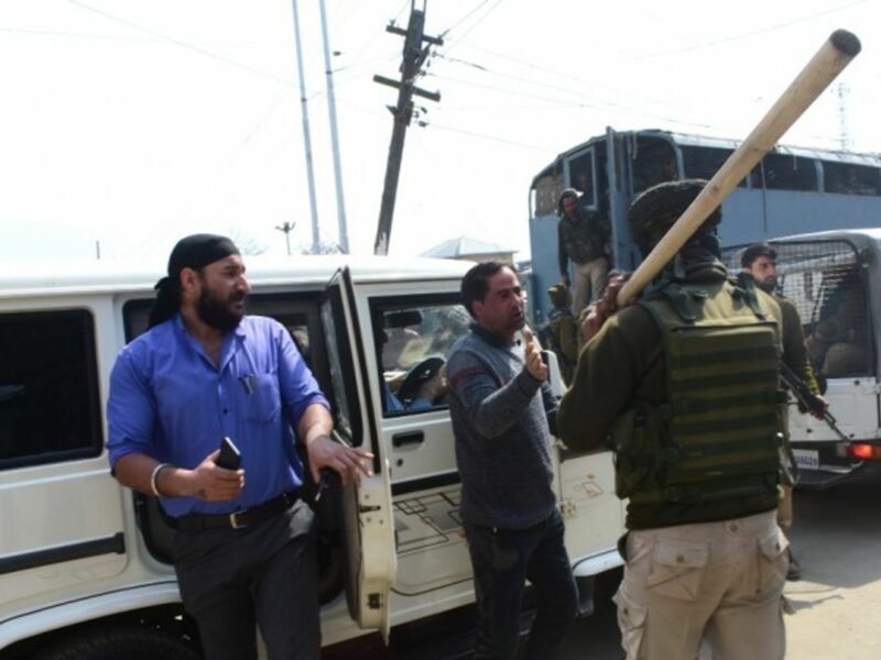 Family members of inmates of Srinagar Central Jail clash with police, while police vehicles leave from the Central Jail in Srinagar, in Indian Administered Kashmir.