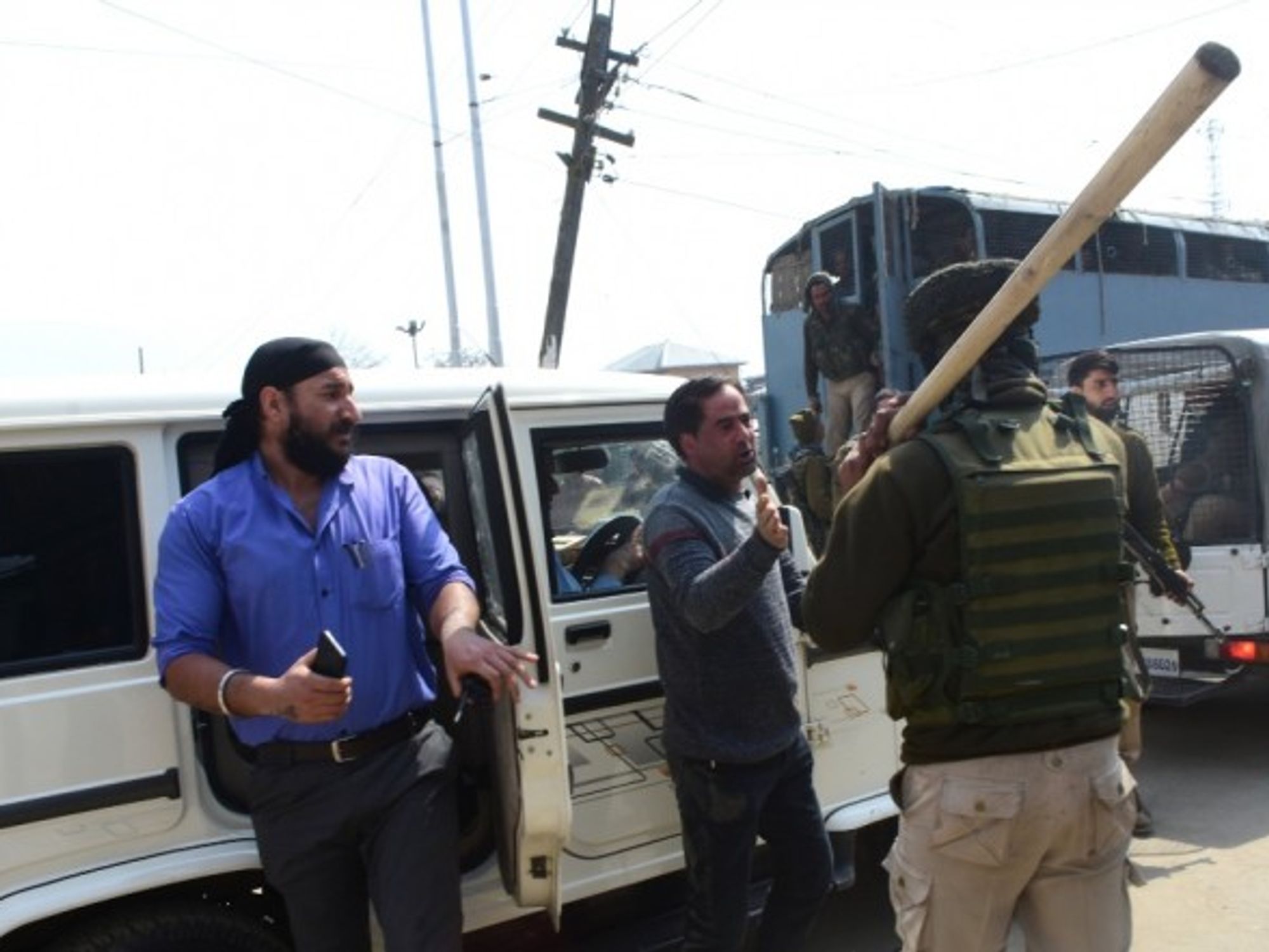 Family members of inmates of Srinagar Central Jail clash with police, while police vehicles leave from the Central Jail in Srinagar, in Indian Administered Kashmir.