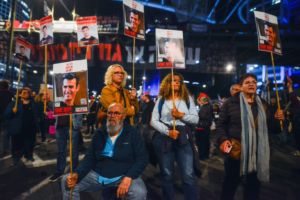 Family members of Israeli hostage protest in the street.