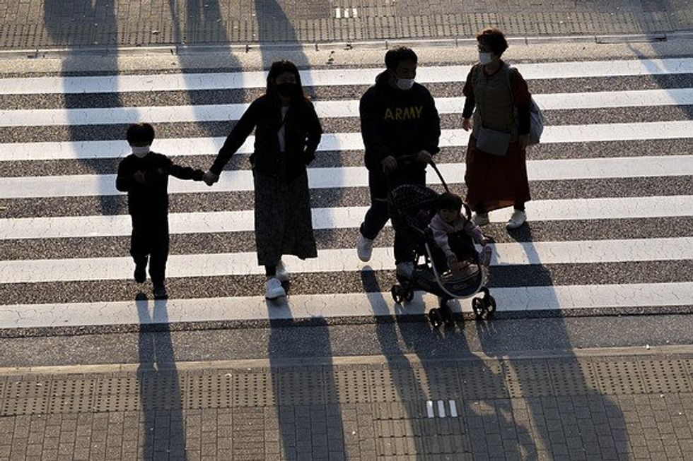 Family walking across a crosswalk.