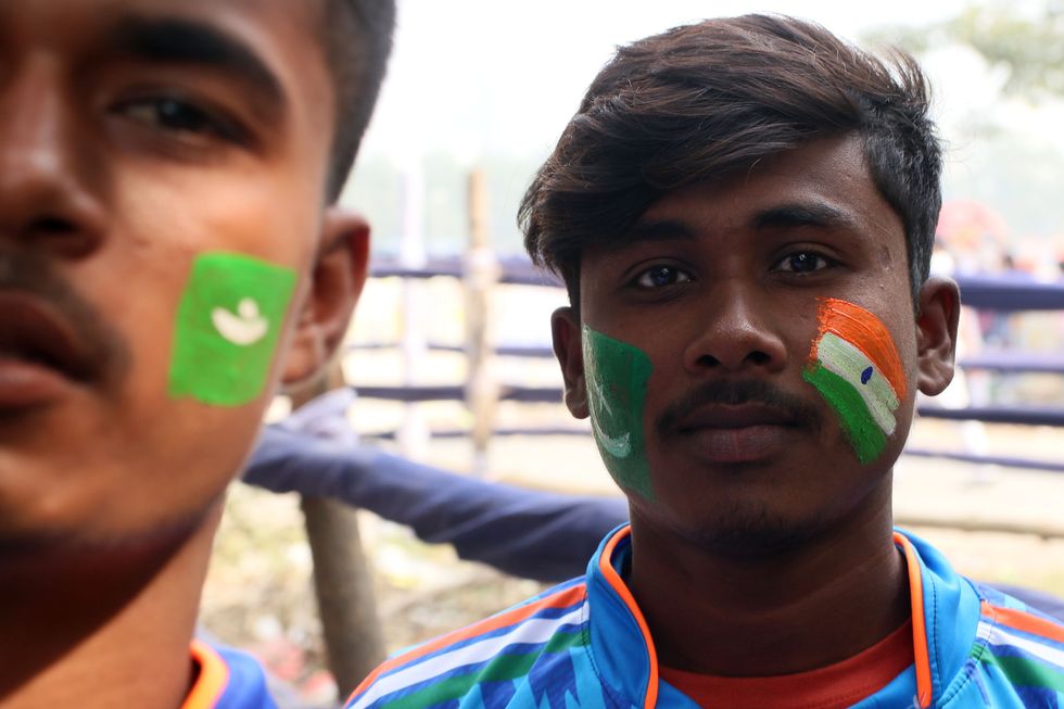 Fans of Pakistan and India are seen with their National flag paint in his face during