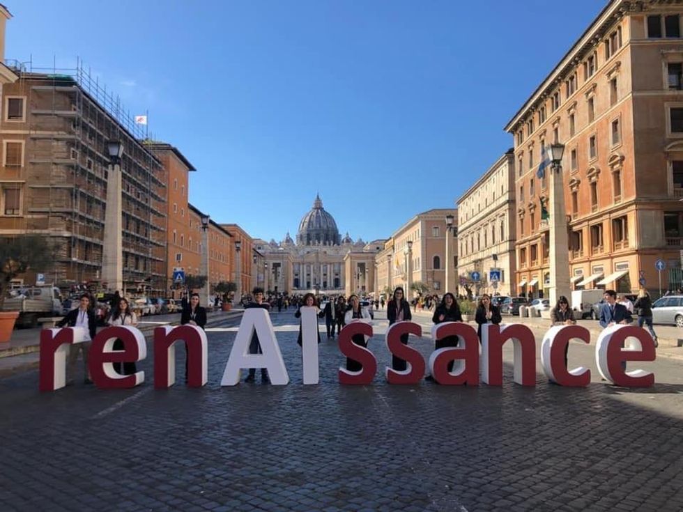 Father Paolo Benanti's RenAIssance Foundation's logo in front of the Vatican City