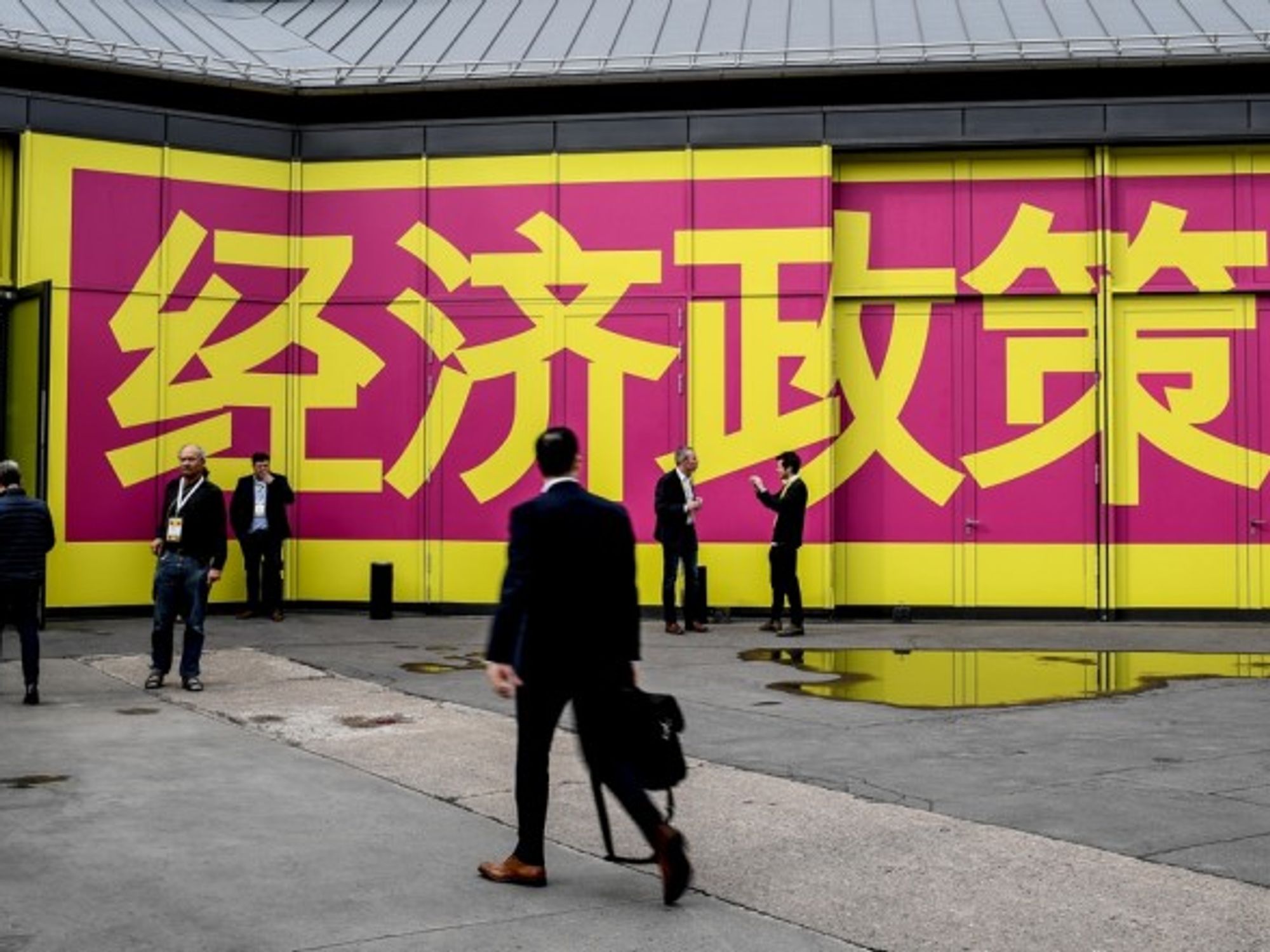 FDP delegates in Berlin heading to party conference in April, 2019, walking along under the Chinese lettering ''economic policy'