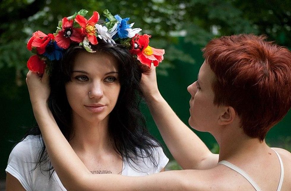 FEMEN activist prepares to crucify herself in front of Sofia Kievska Church to protest against anti-ukrainian politics of Moscow Patriarchy
