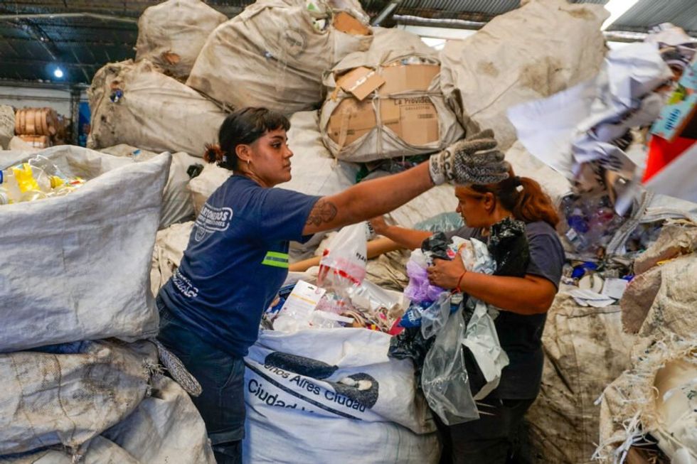 Fernanda Centurión and Gabriela Villalba manually sort recyclables. Argentina’s recycling sector is struggling as deregulated imports and falling material prices drive waste-pickers out of work.