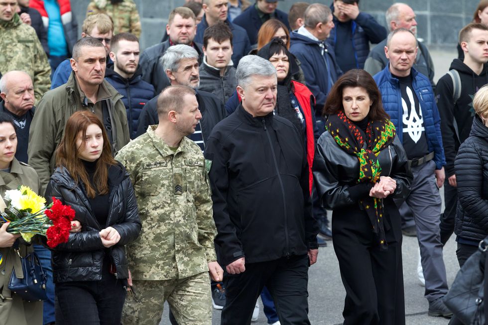 Fifth President of Ukraine Petro Poroshenko, his wife Maryna Poroshenko and brother Stepan Barna during a memorial service for Ukrainian servicemen.