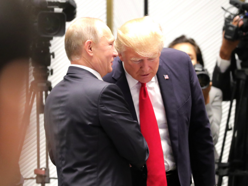 File photo of ​Vladimir Putin whispering into Donald Trump's ear as they meet on the sidelines of the APEC Economic Leaders’ Meeting back in 2017.