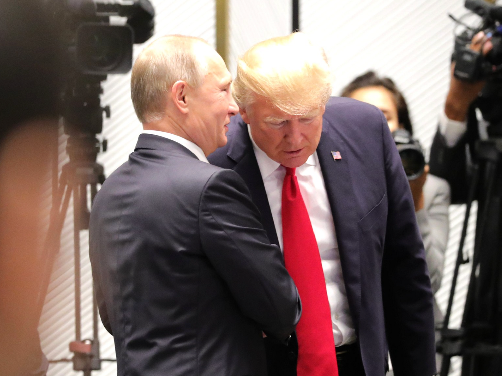File photo of ​Vladimir Putin whispering into Donald Trump's ear as they meet on the sidelines of the APEC Economic Leaders’ Meeting back in 2017.