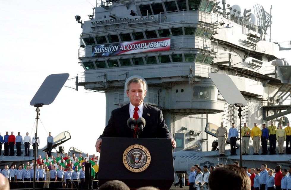 File photo of then U.S. President George W. Bush delivering his "Mission Accomplished" speech aboard the aircraft carrier USS Abraham Lincoln off the California coast on May 1, 2003.