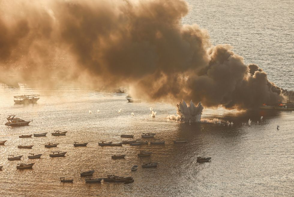 Fire and smoke rise after Israeli stroke a fishing boat inside the seaport of Gaza City, in Gaza, on October 10, 2023.