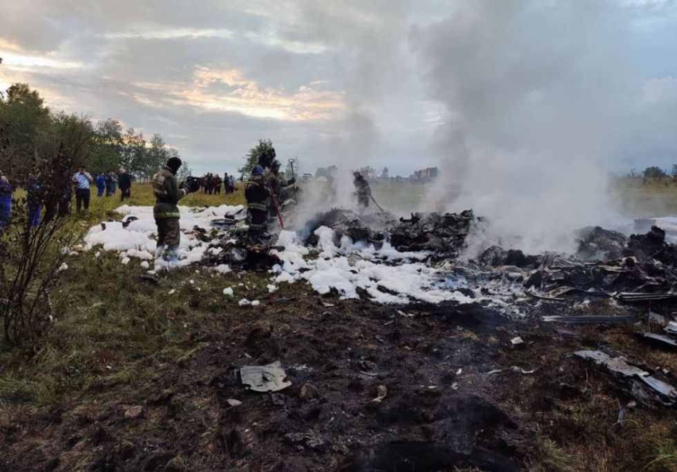 Firefighters on the site of the crash of the private plane transporting Prigozhin.