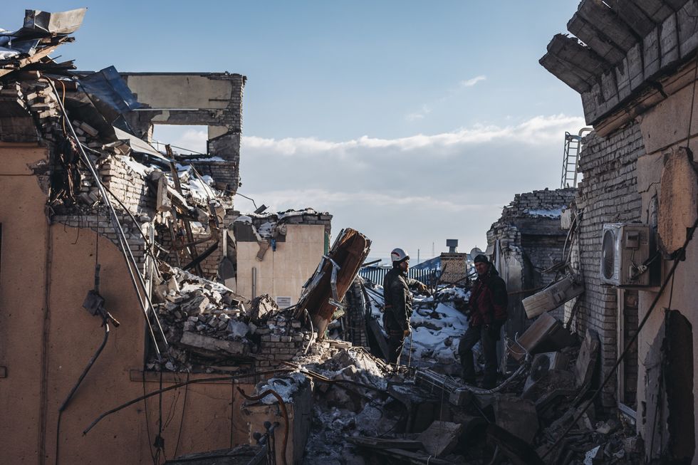 Firefighters working in a building in Kharkiv.