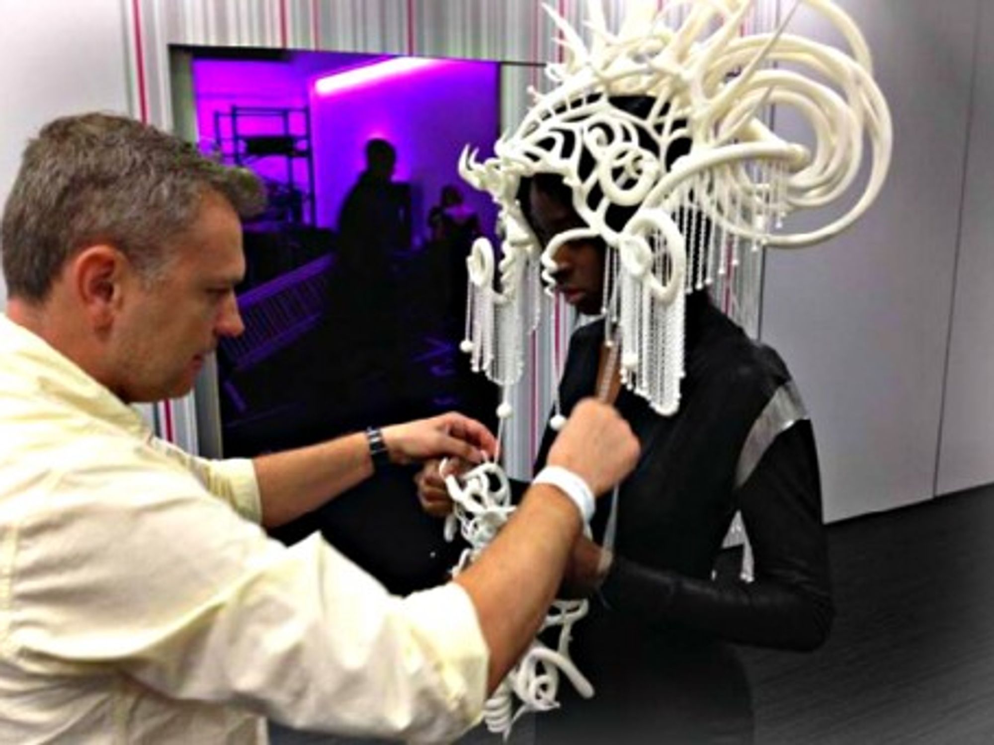 Fitting a 3D-printed headpiece on a model before a live show