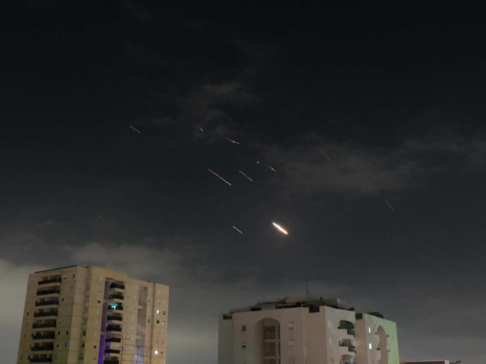 Flares from ballistic missile and drone explosions over Tel Aviv.