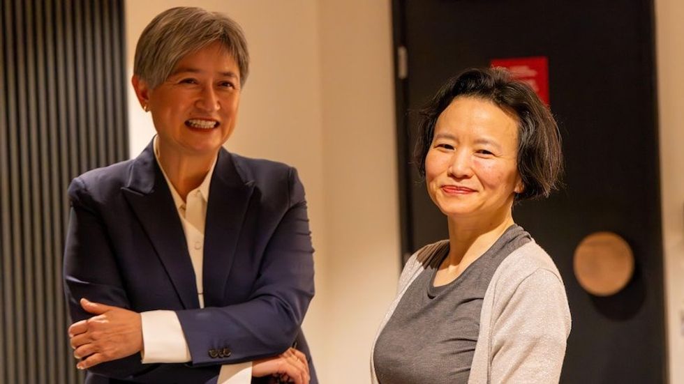 Foreign Minister Penny Wong with Australian journalist Cheng Lei (right) after she arrived home in Melbourne.