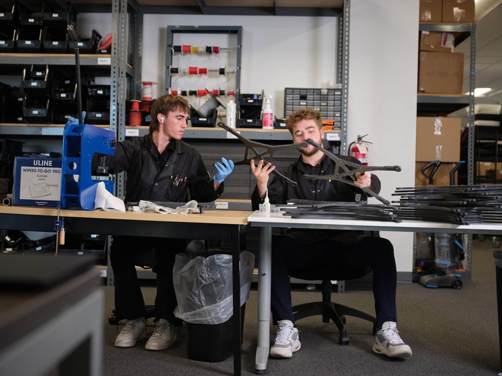 Fortem employees press fitting fasteners and clean carbon fiber drone frames.
