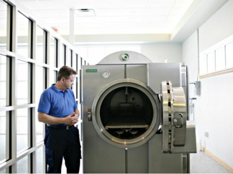 Founder of Resomation Ltd. Sandy Sullivan next to a "resomator"