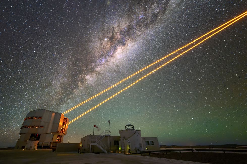 Four powerful laser beams leaving Unit Telescope 4 in front of the Milky Way at ESO's Very Large Telescope in the Atacama desert.