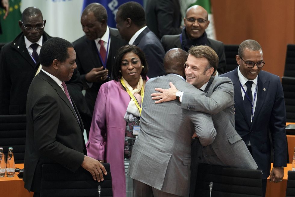 French President Emmanuel Macron (2nd from left) welcomes participants to the ''Compact with Africa'' - G20 Investment Summit 2023 conference.