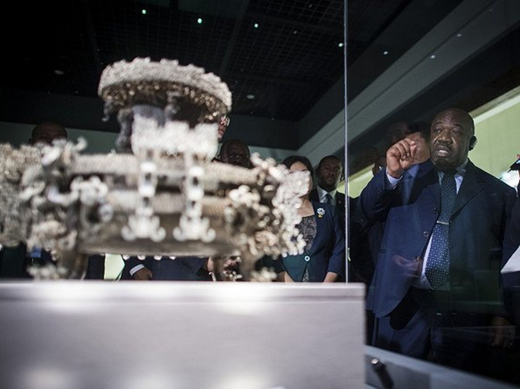 Gabonese President Ali Bongo Ondimba behind a glass box.