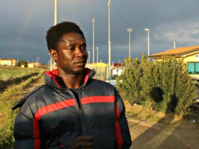 Gambian immigrant Abu Bakar at the entrance to the Mineo camp