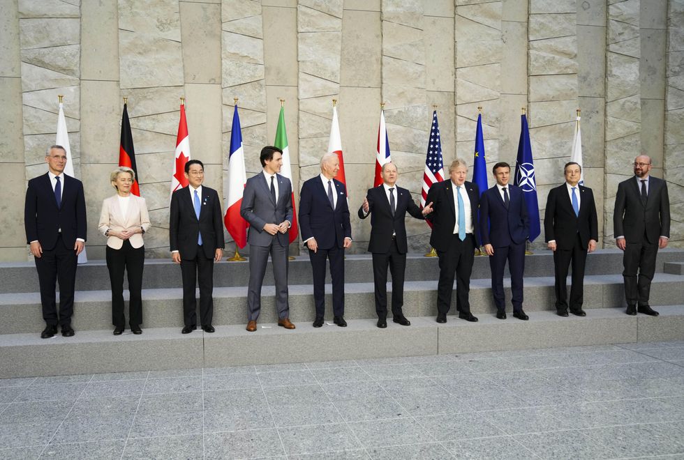 German Chancellor Olaf Scholz gestures as he joins fellow leaders for a G7 family photo at the NATO headquarters in Brussels, Belgium on Thursday, March 24, 2022
