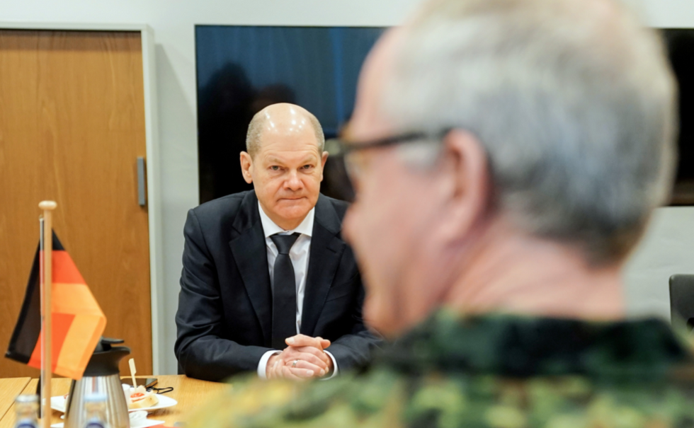 German Chancellor Olaf Scholz sat at a table with a member of the Bundeswehr during a visit of the German Army's Operations Command in Brandenburg on March 4.