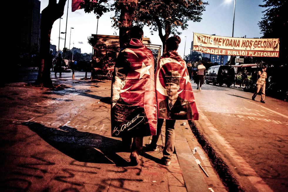 Gezi Park protesters wearing Turkish flags with the portrait Kemal Ataturk in 2013