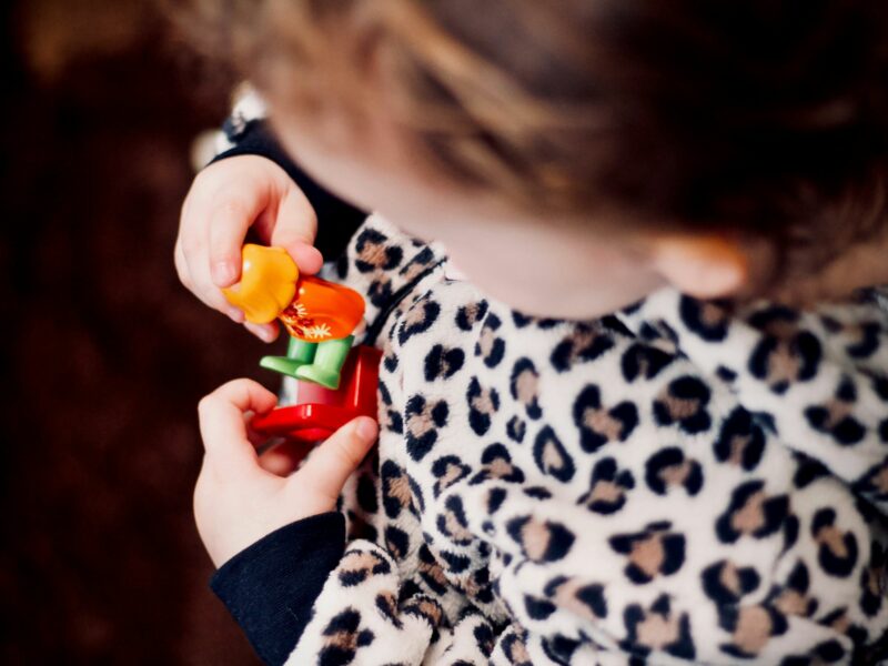 Girl holding plastic toys, Tokyo, Japan, Nov. 3, 2017.