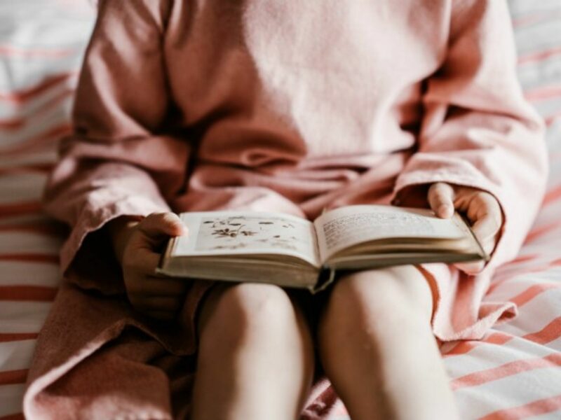 Girl reading a book before bedtime