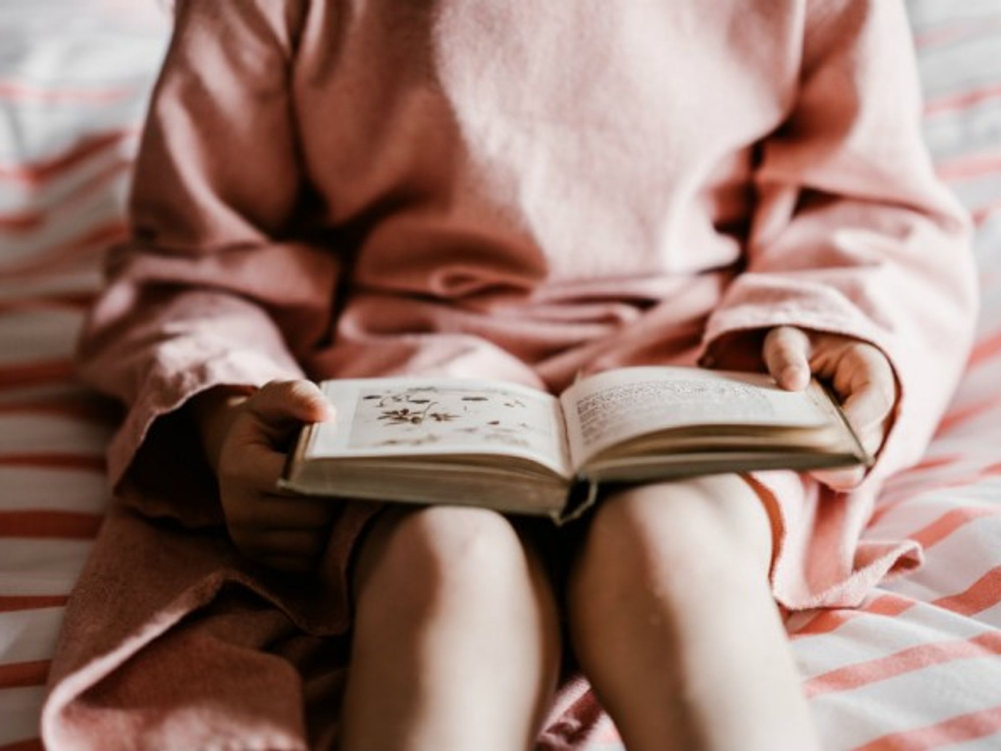 Girl reading a book before bedtime