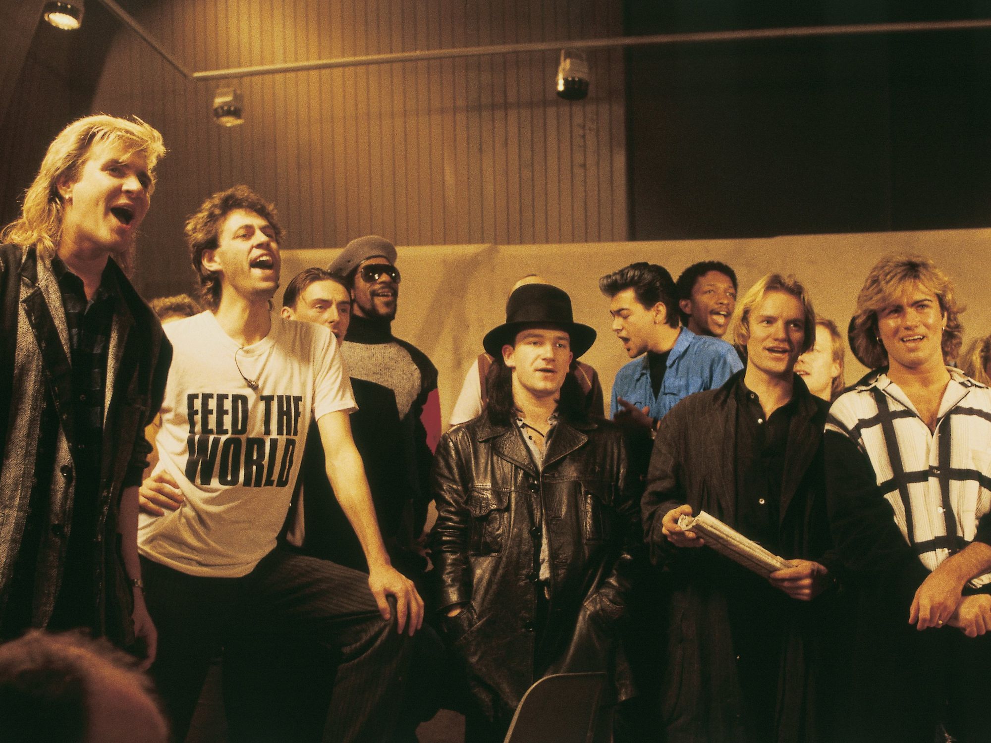 Group photo of Band Aid supergroup with Bob Geldof, Bono, Sting and George Michael, among others, pictured singing