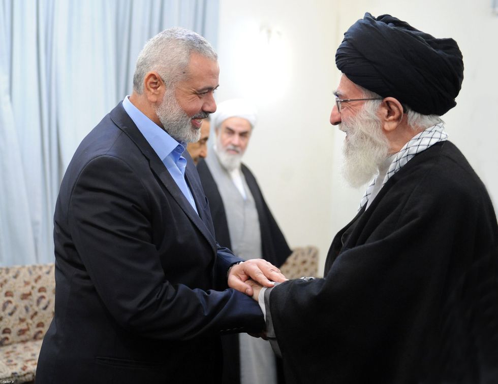Hamas chief Ismail Haniyeh greets Iranian Supreme Leader Ayatollah Ali Khamenei in Tehran on Tuesday just hours before the Palestinian leader was killed..